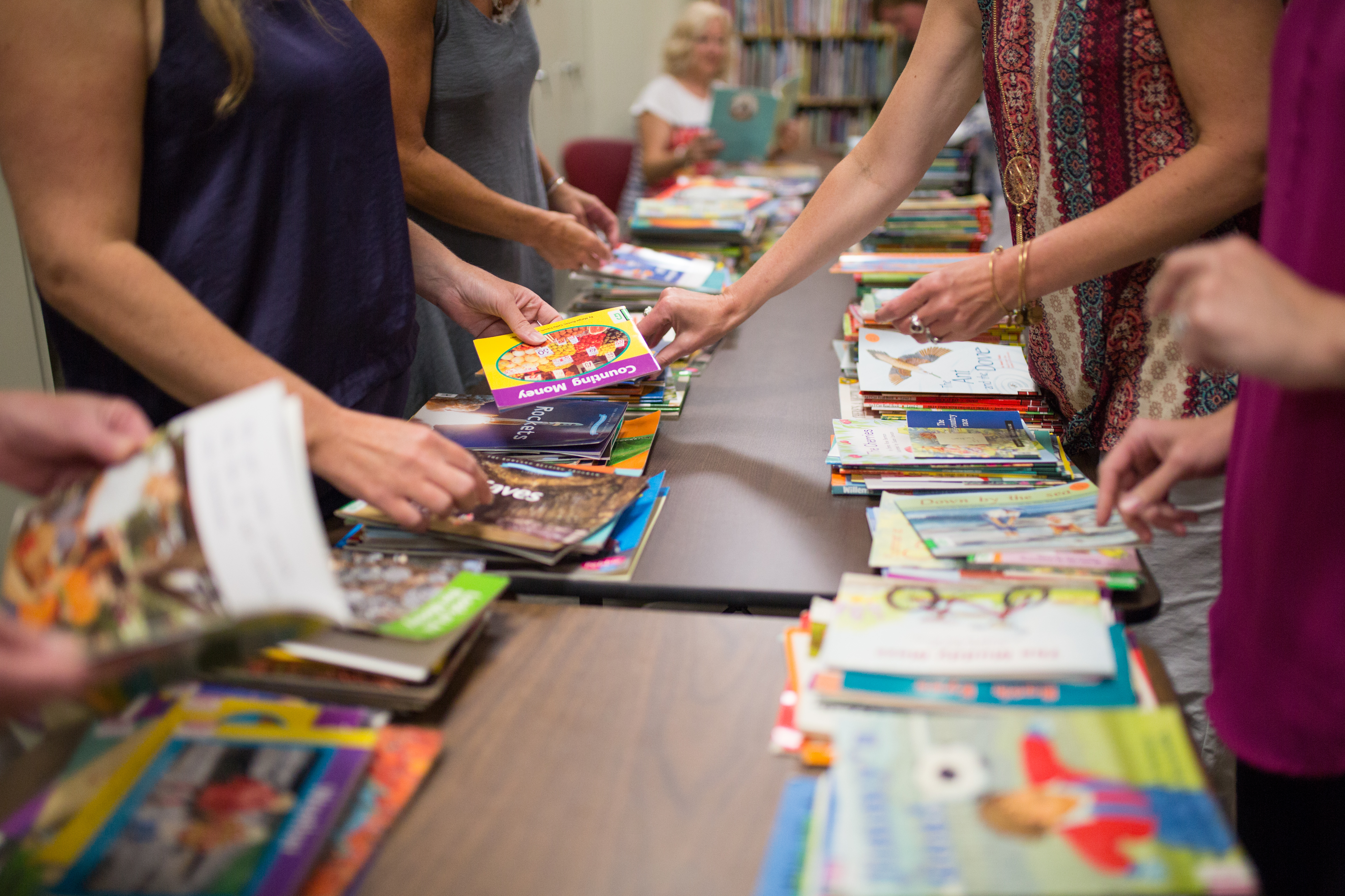 Children's books on a long table.