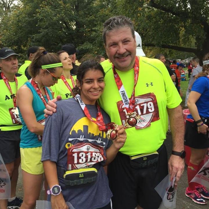 Hanna and her father John Adams wearing race medals after the Marine Corp Marathon