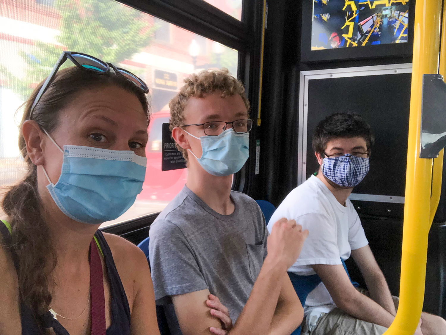 Three people riding the T with masks