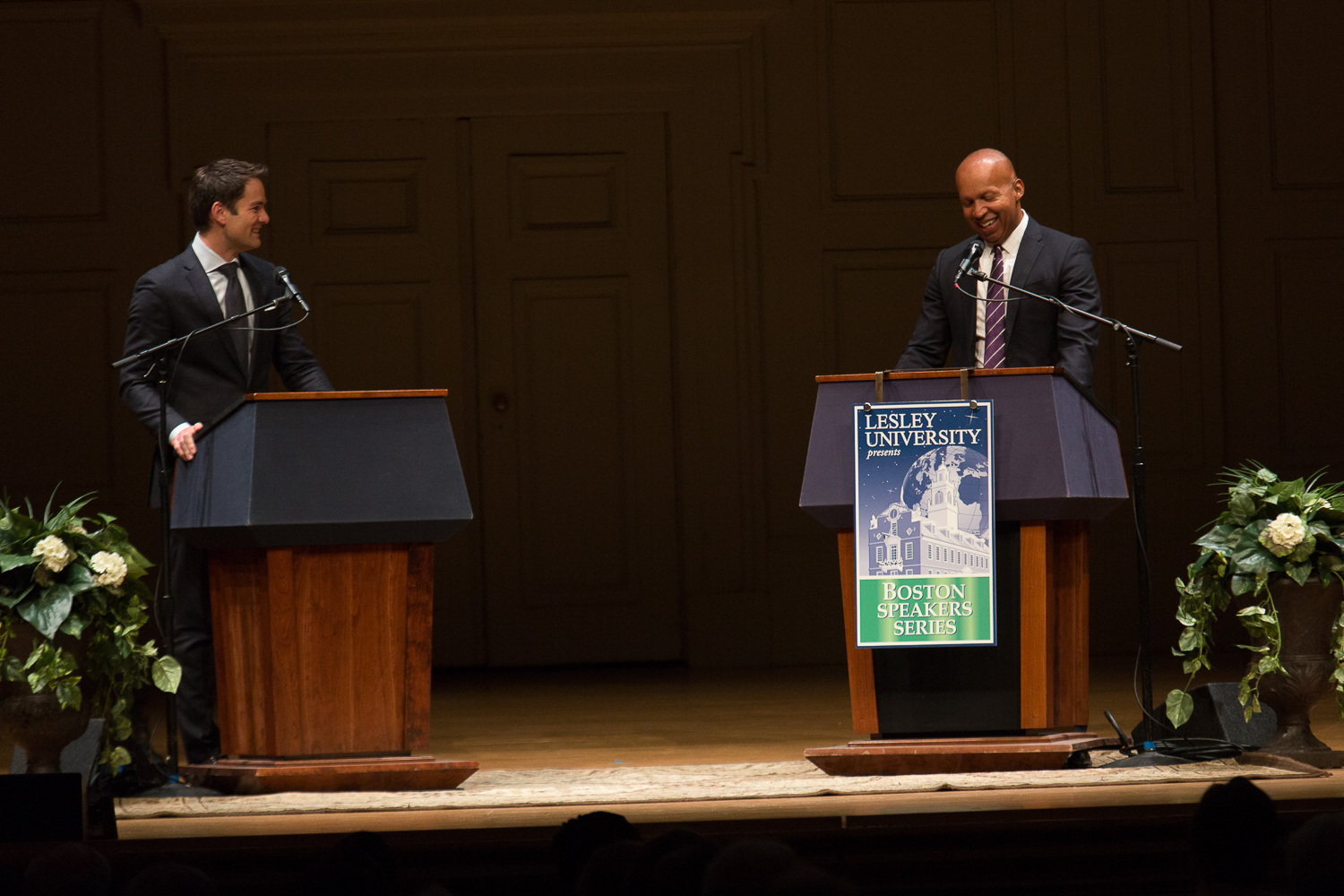 Jared Bowen and Bryan Stevenson on stage together, both behind podiums