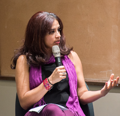 Mariya Taher speaks into a microphone at the panel.