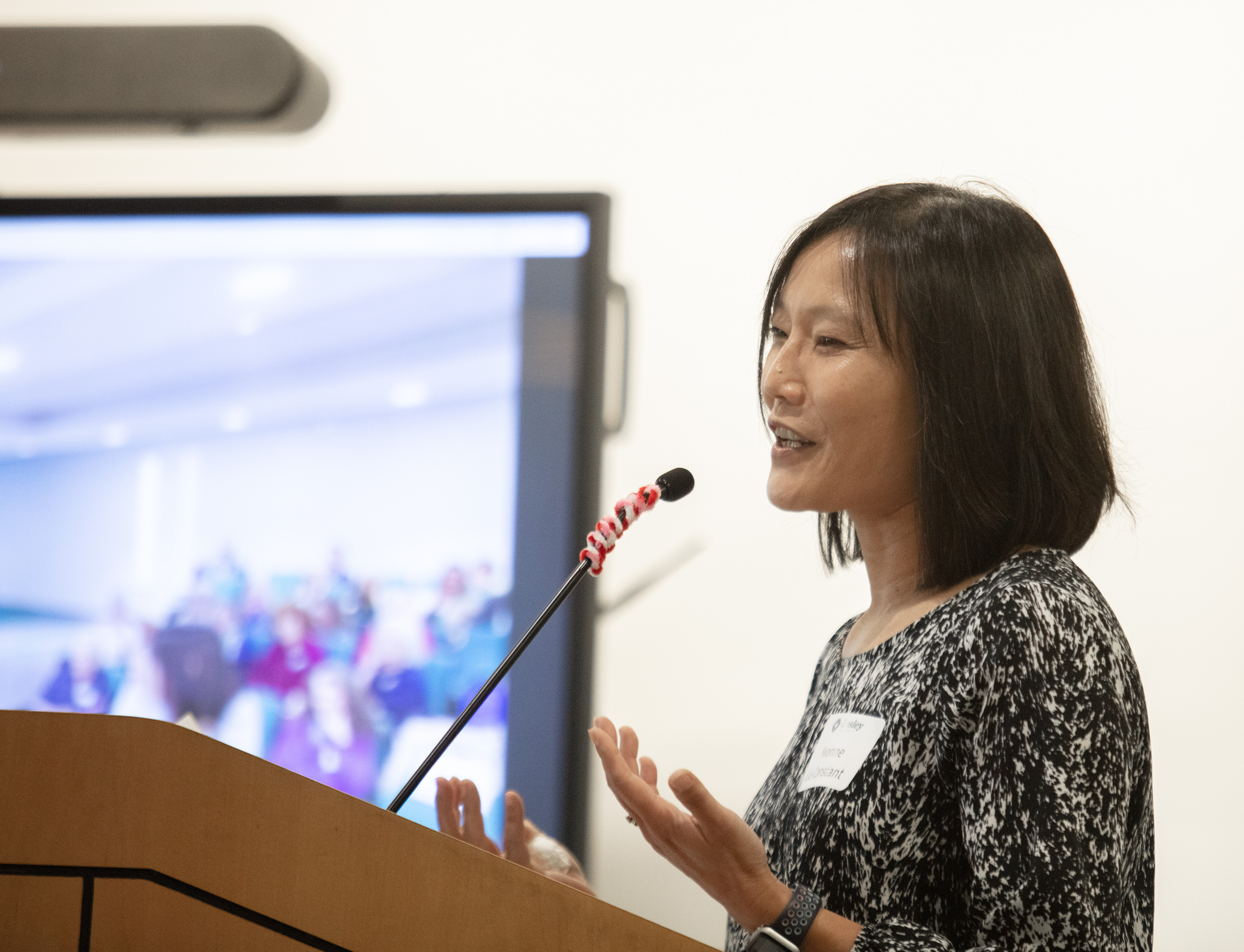 yvonne liu-constant smiling and speaking at podium