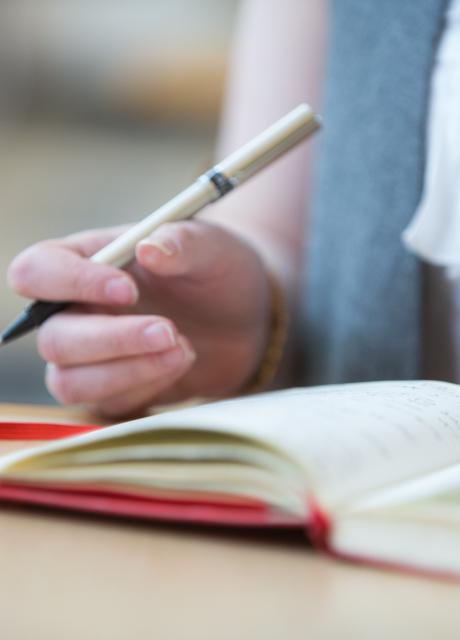 closeup of woman writing in notebook