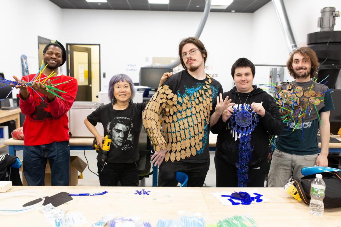 students show off their work in the fabrication studio