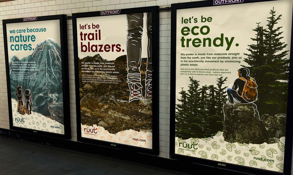 three large poster advertisements with illustrated forest landscapes framed on the subway wall