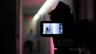 camera recording a scene of person in hallway 