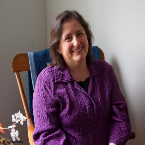 faculty jane brox sitting in rocking chair
