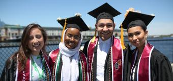 Four students pose at Commencement