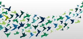 blue and green paper birds flying across a white background