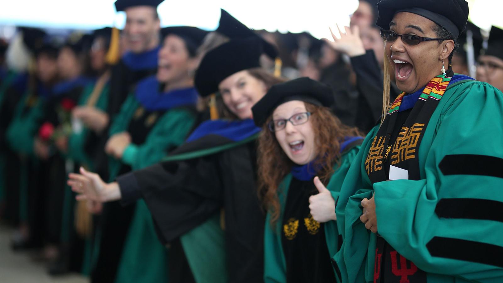 Lesley University smiling grads and faculty commencement 2022