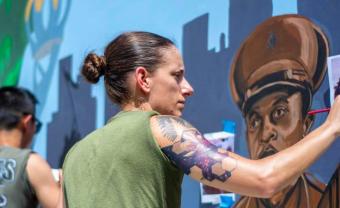 Sgt. Elize McKeley painting a mural