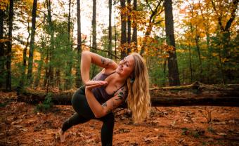 Yoga therapist Sophie Lyons '21 does yoga in the woods.