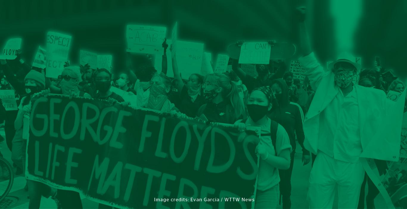 Green filter layered over image of protesters holding various Black Lives Matter-themed signs