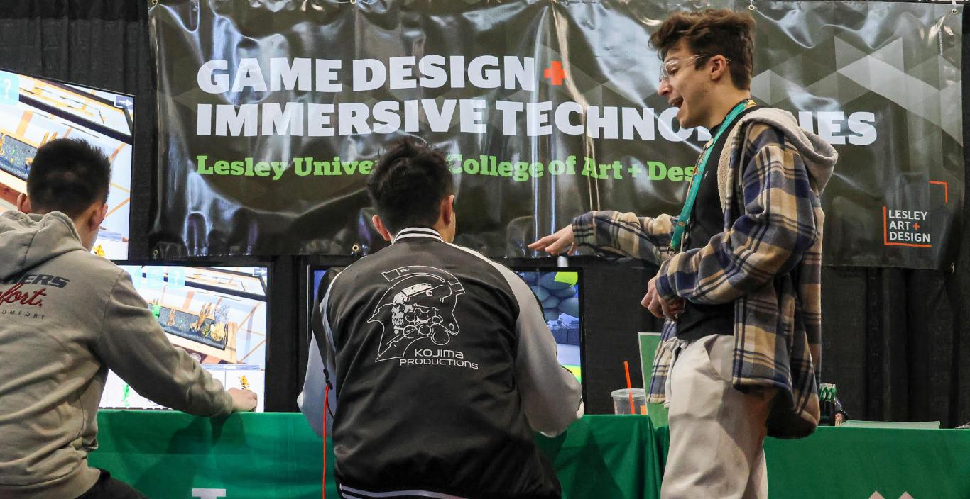 Student Jake Anderson shows PAX attendees a game built at Lesley