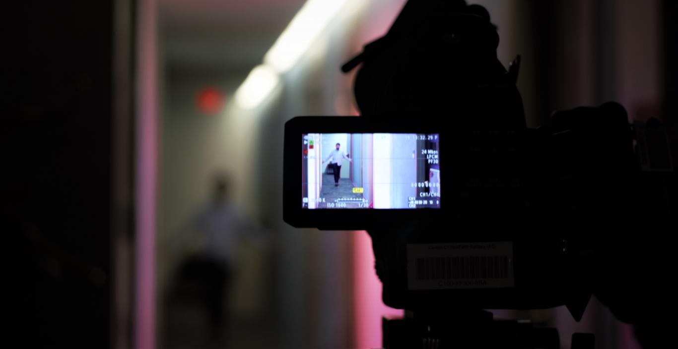 camera recording a scene of person in hallway 