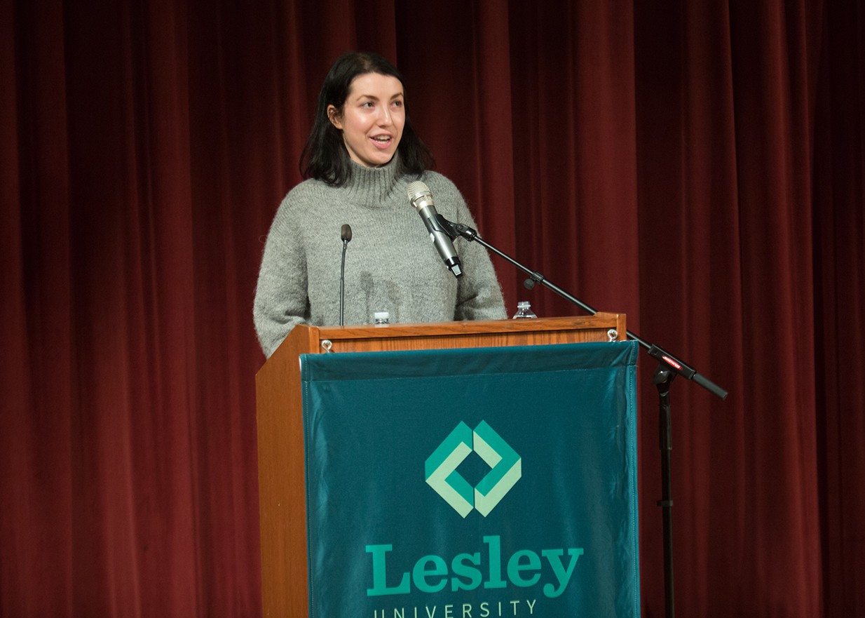 Lesley student Amanda Fata introduces Rick Steves to the audience in Marran Theater