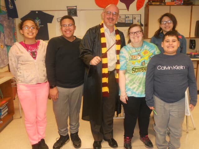 Bert Carter dressed as Harry Potter with students.