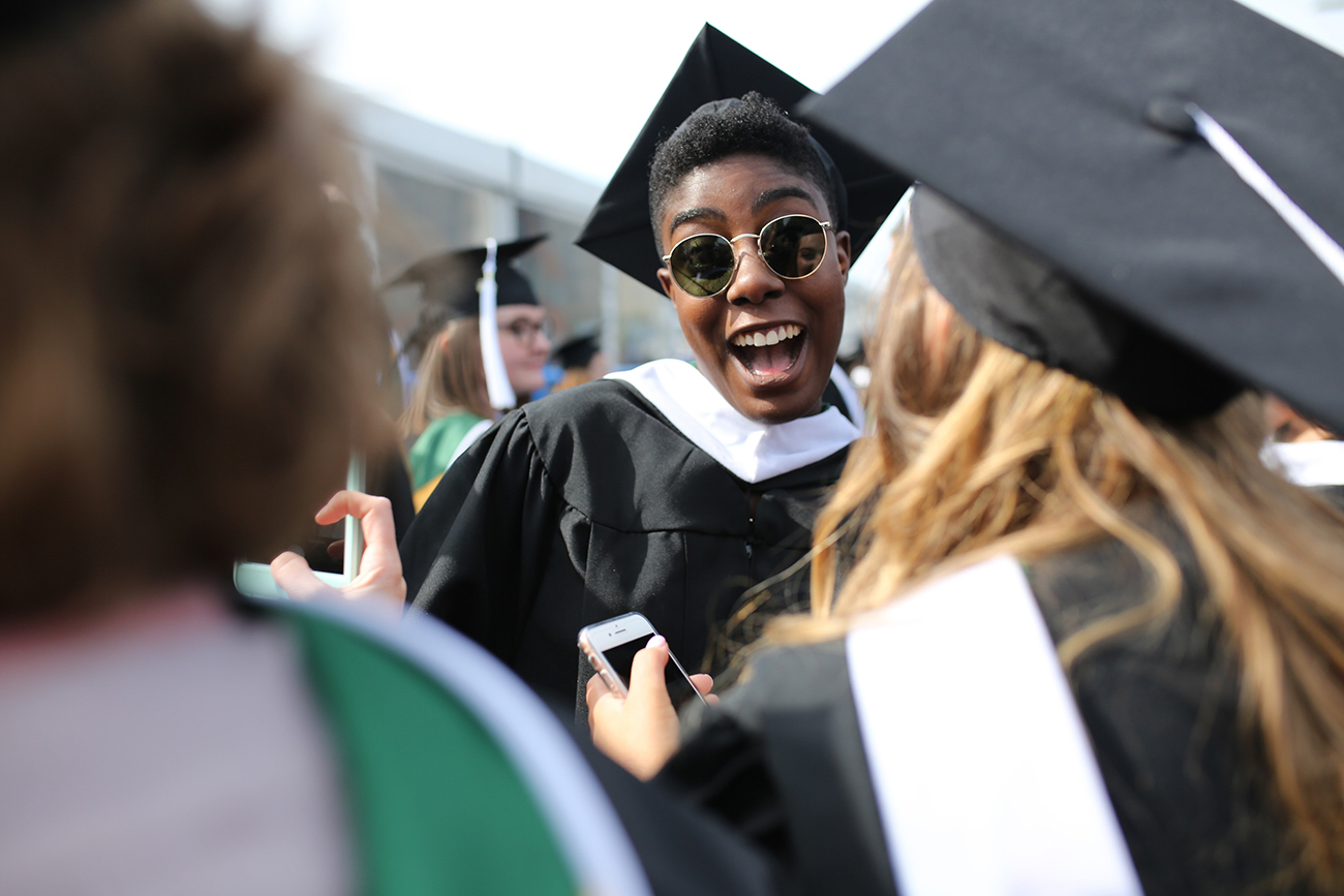A female student smiles excitedly before the ceremony.