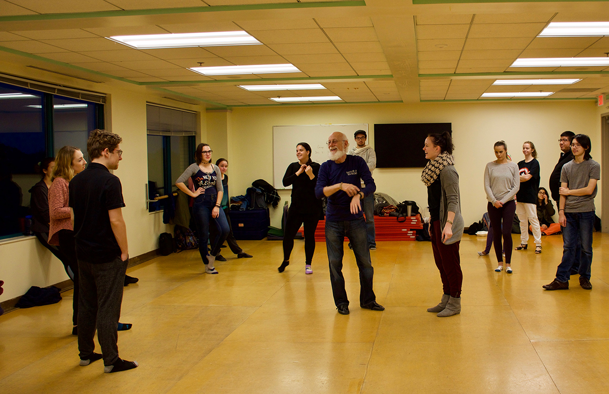Students pause for a laugh during swing dance class in dance studio.