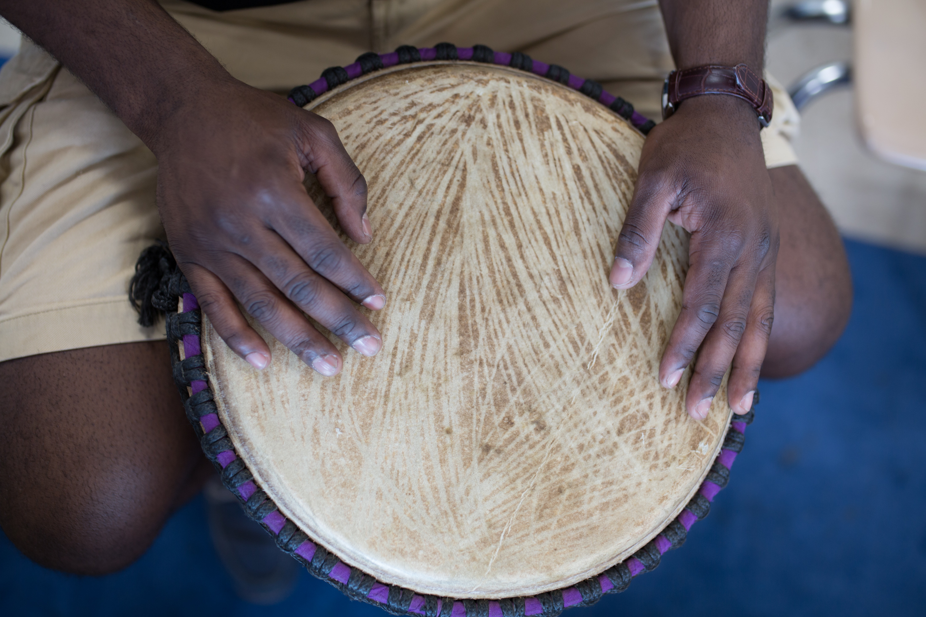 Jonathan Mande's hands on one of his traditional African drums.
