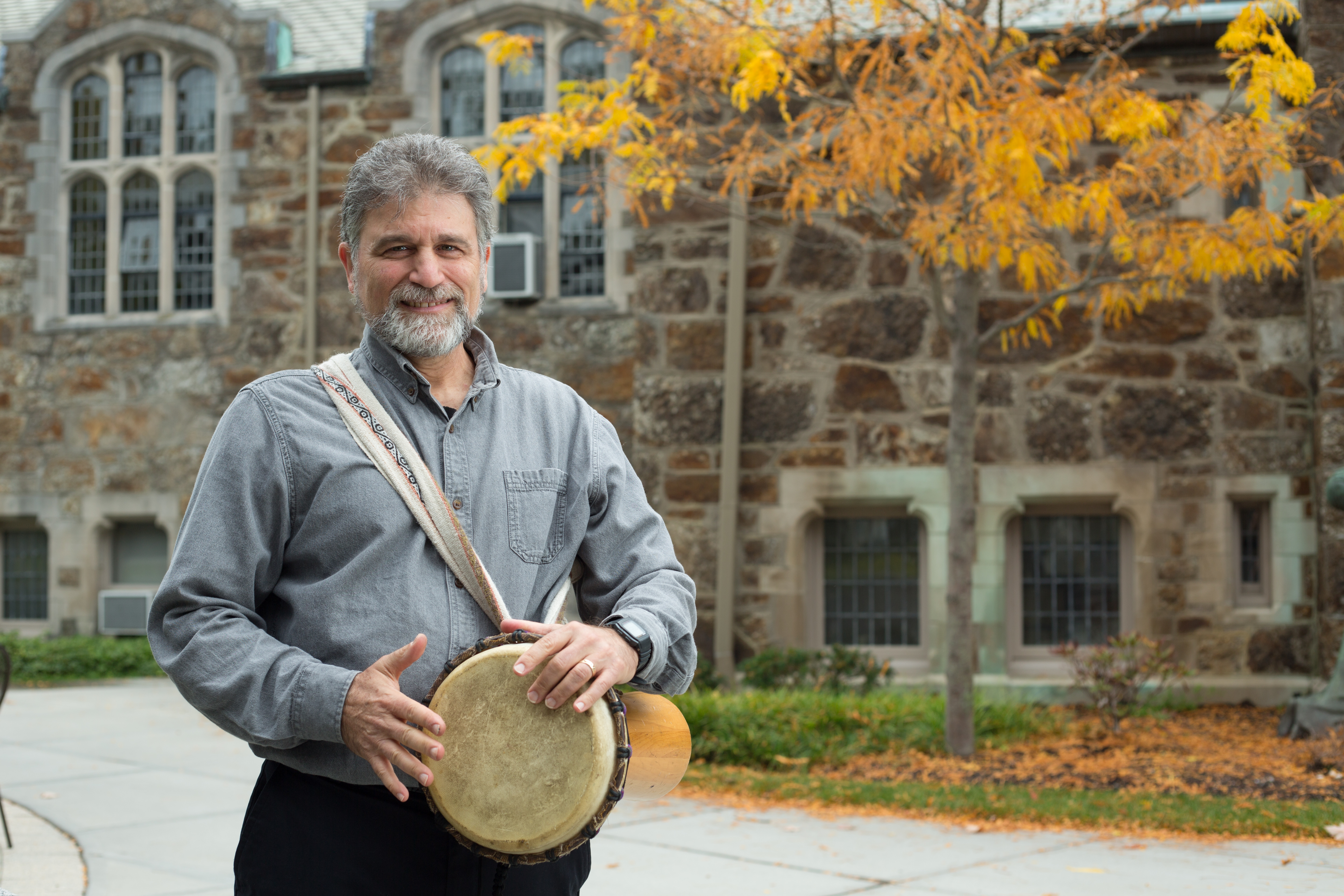 Kossak holds a drum on campus.