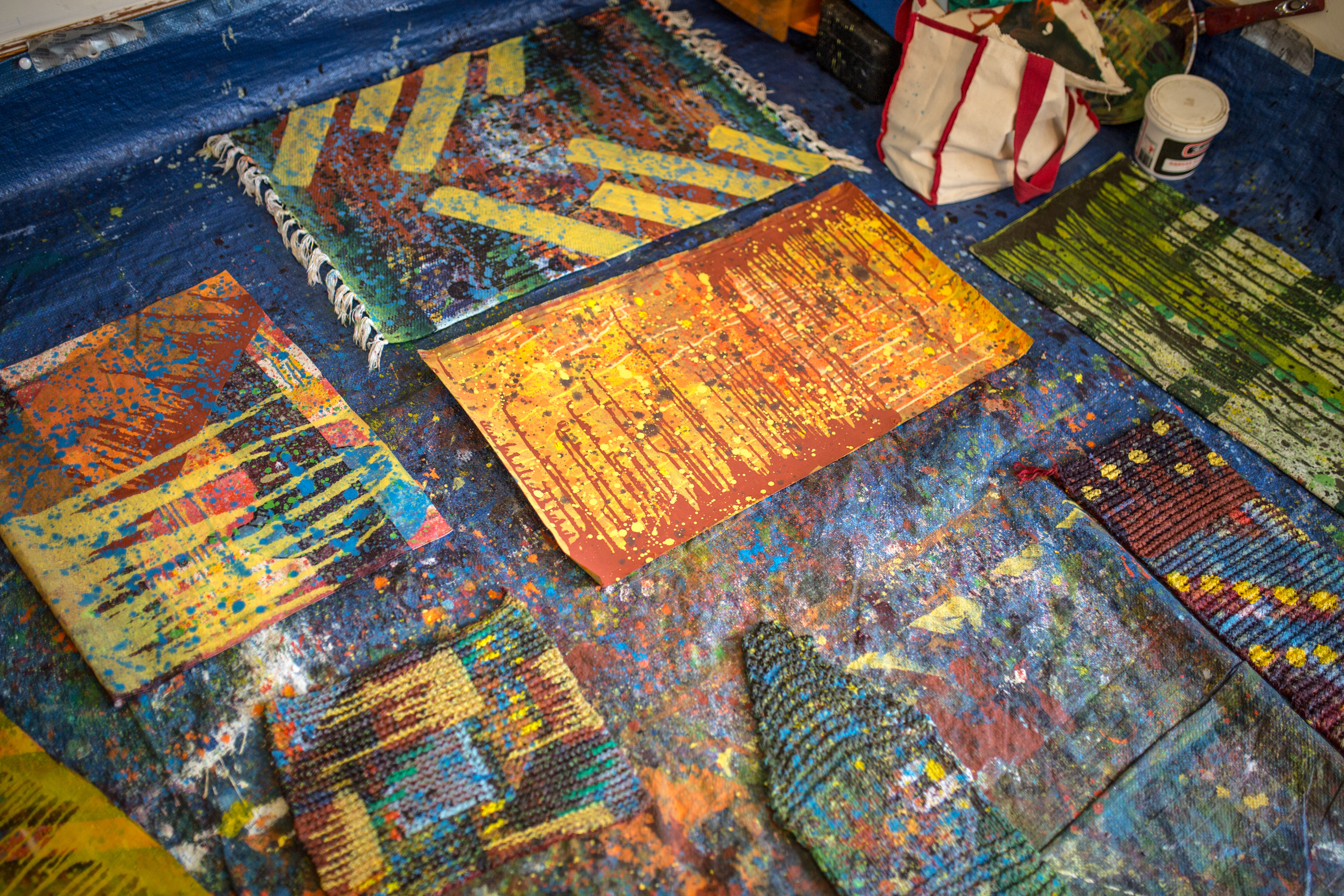 Miranda Aisling's artwork on the floor of her studio, abstract and colorful