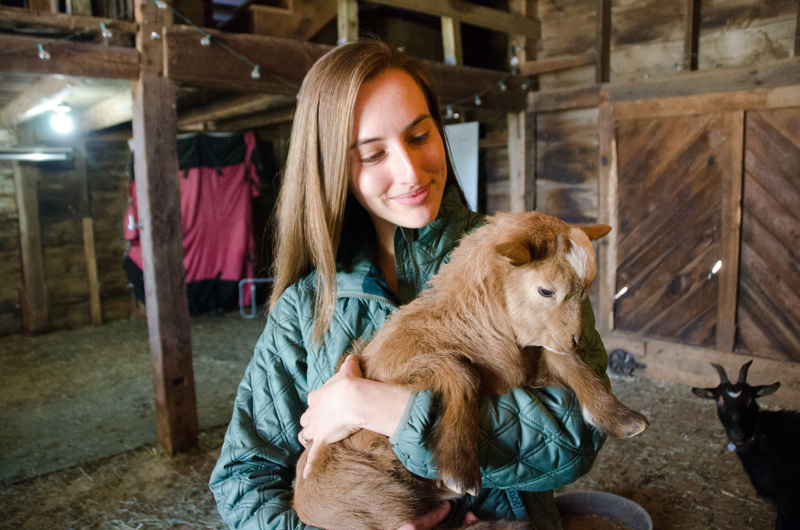 Samantha Sundermeyer with a baby goat at Cultivate Care Farm