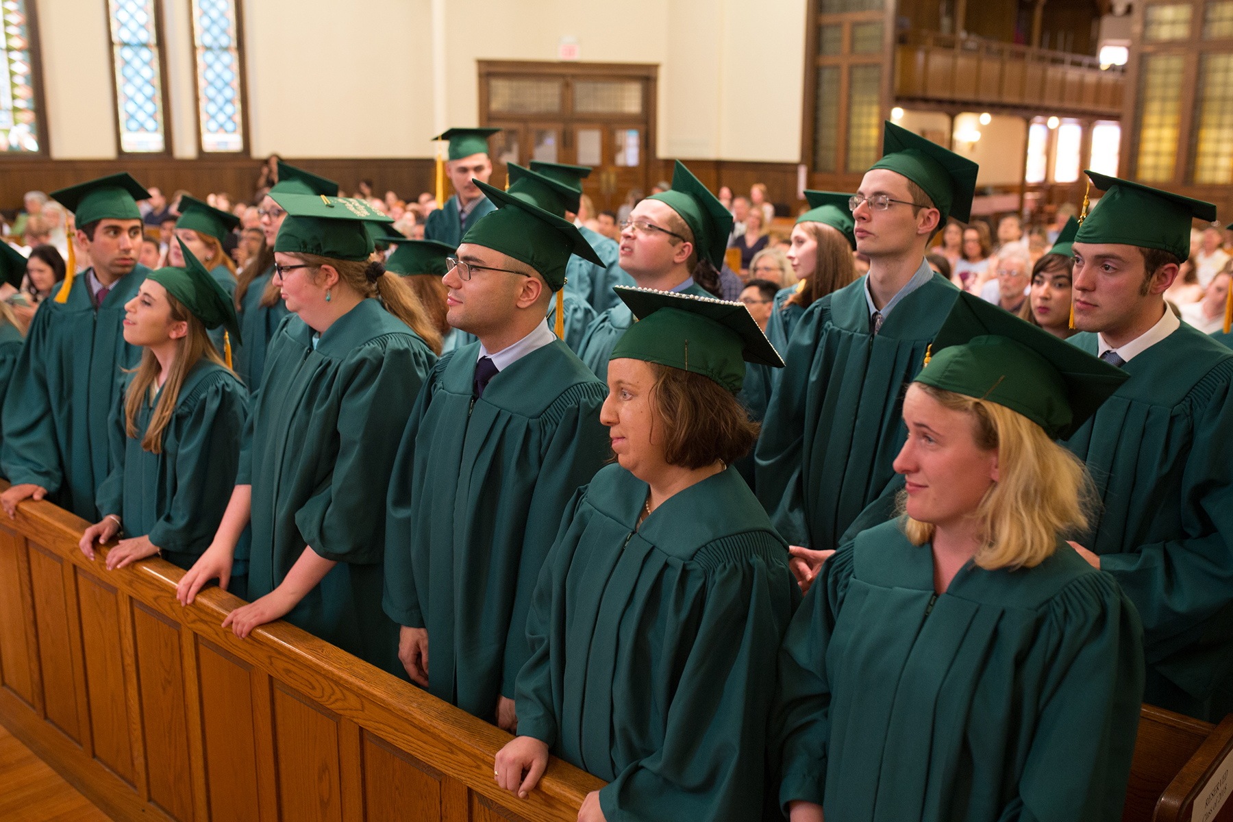 The Class of 2018 is pictured standing and listening during the graduation ceremony.