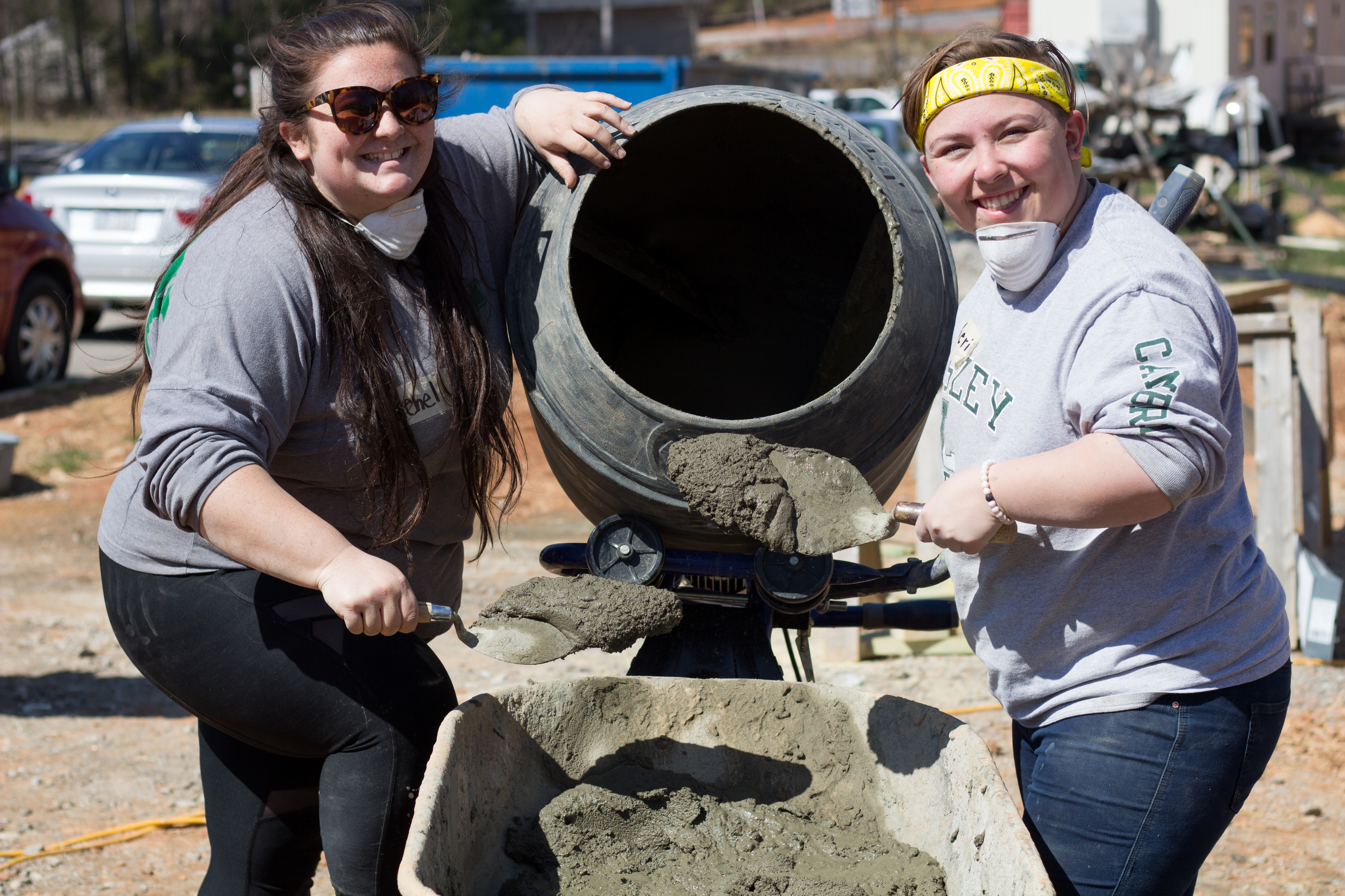 Rachel DiGangi mixing cement on Alternative Spring Break with another student.