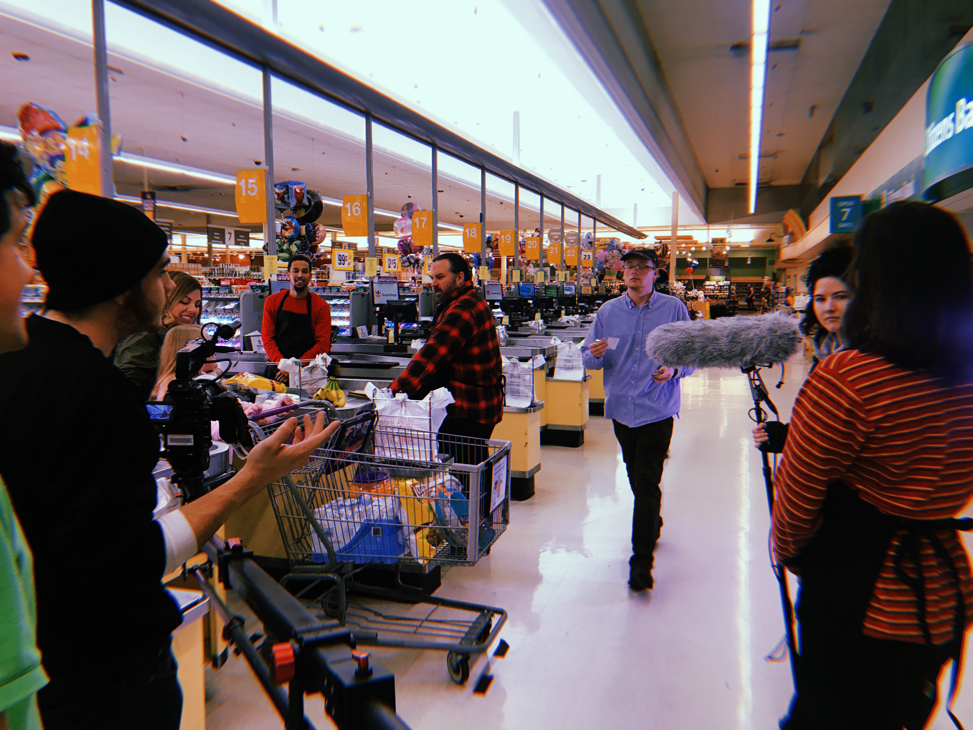 students filming a movie in a grocery store 