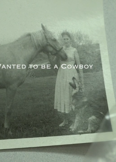 old black and white photo pinned to wall of a woman with horse and dog