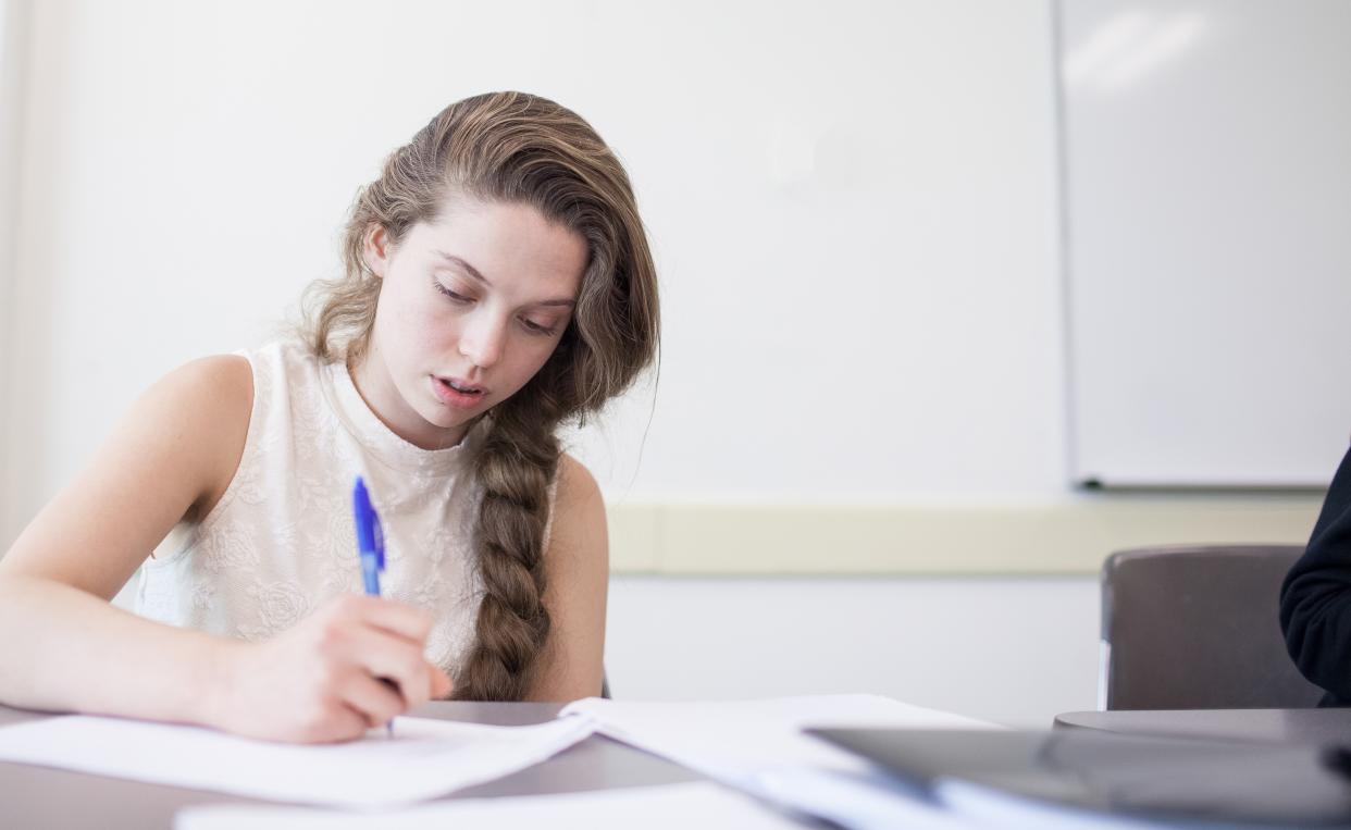 girl writing in class
