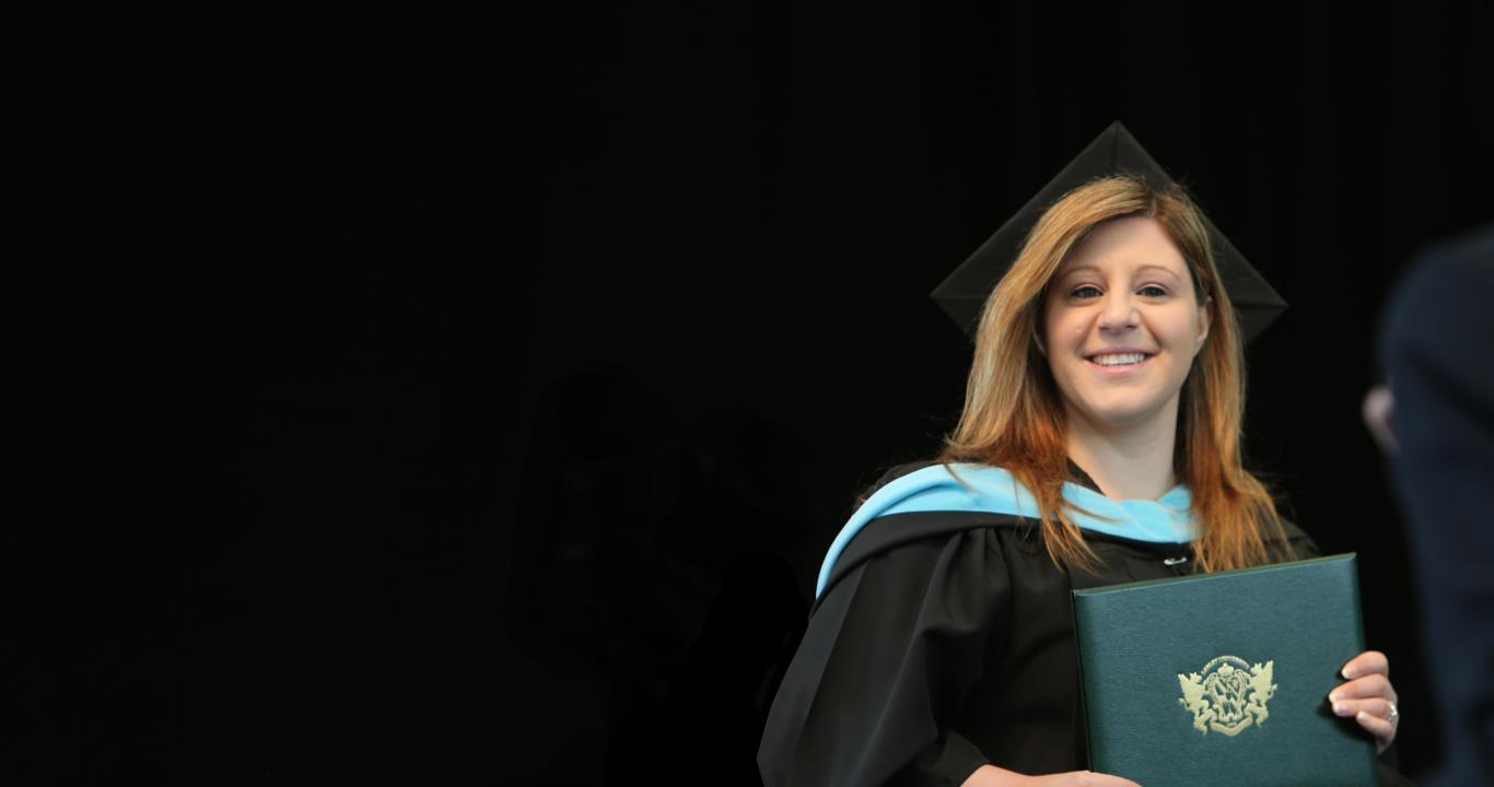 Lesley graduate receiving diploma at graduation