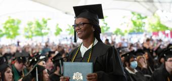 Julette Moore holding her degree at the 2022 Commencement Afternoon Ceremony.
