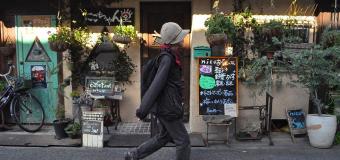 Pedestrian-walking-past-shops-Japan-2018