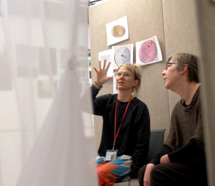 mfa visual arts student and faculty discuss work during a one-on-one critique session