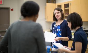 Hannah Willis speaking to colleagues