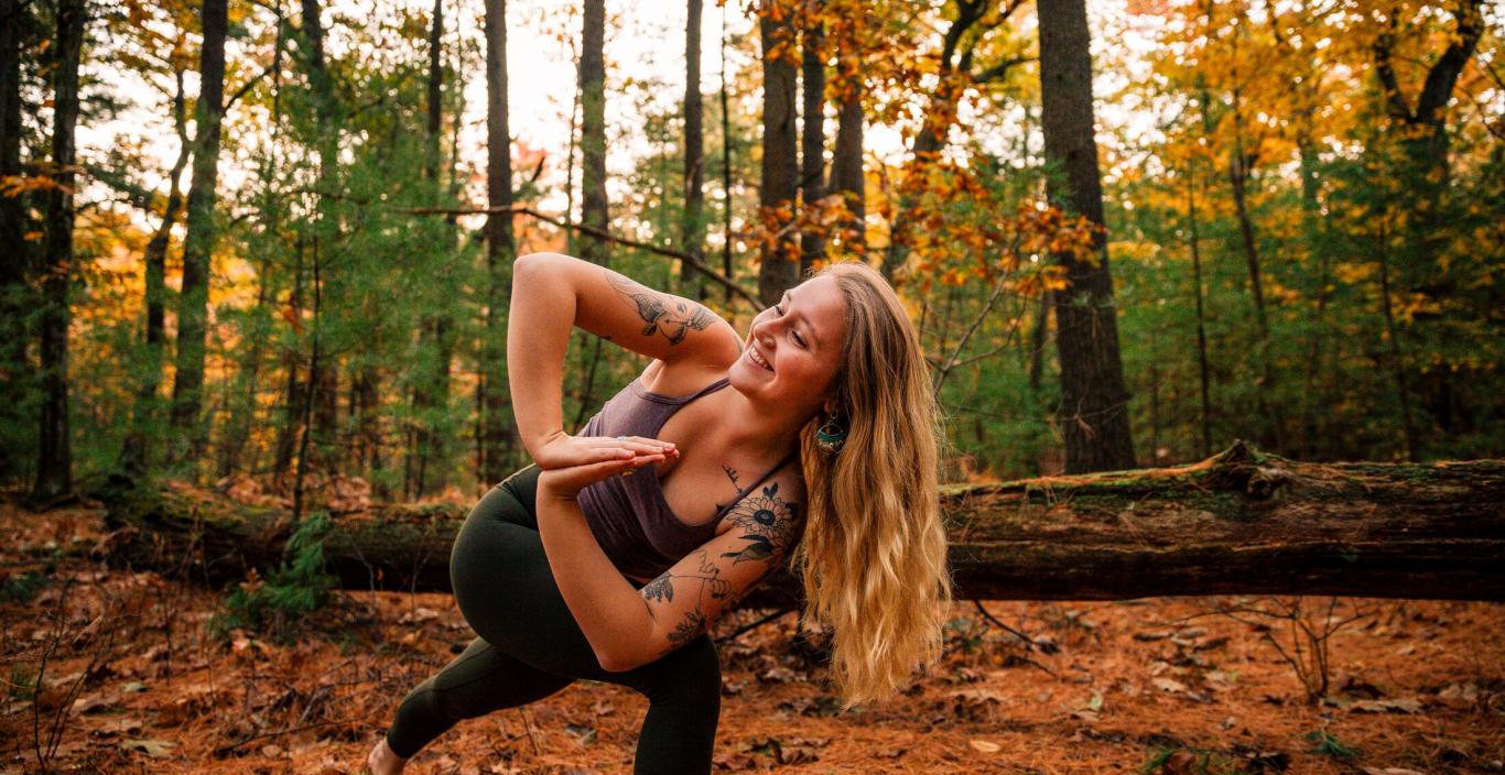 Yoga therapist Sophie Lyons '21 does yoga in the woods.