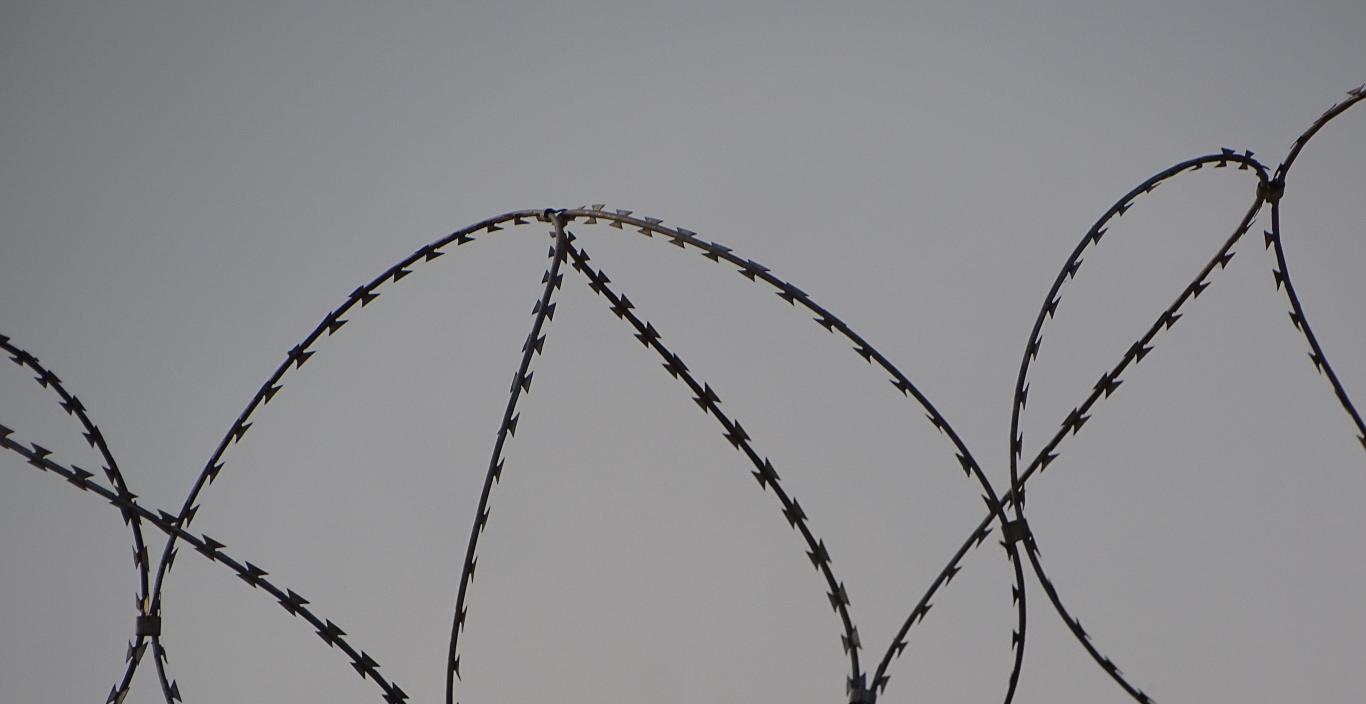 Barbed wire at the top of a fence