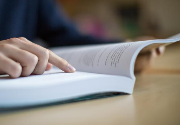 Close-up of student reading a textbook