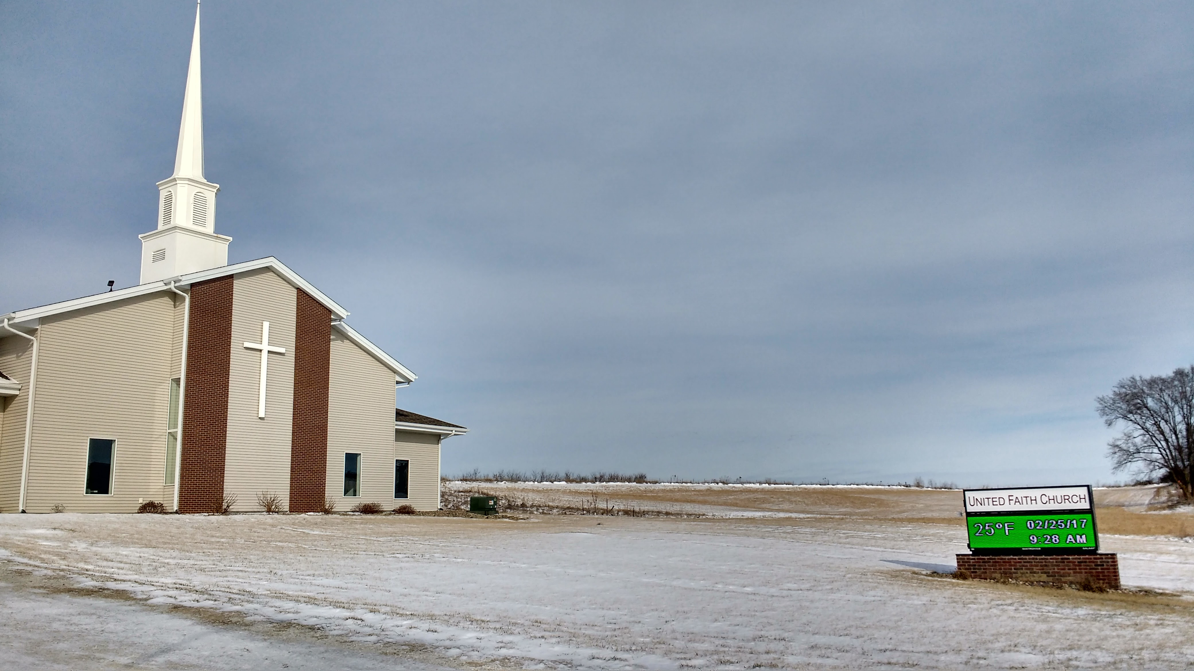 United Faith Church - light snow covering on the ground with a modern looking taupe church.